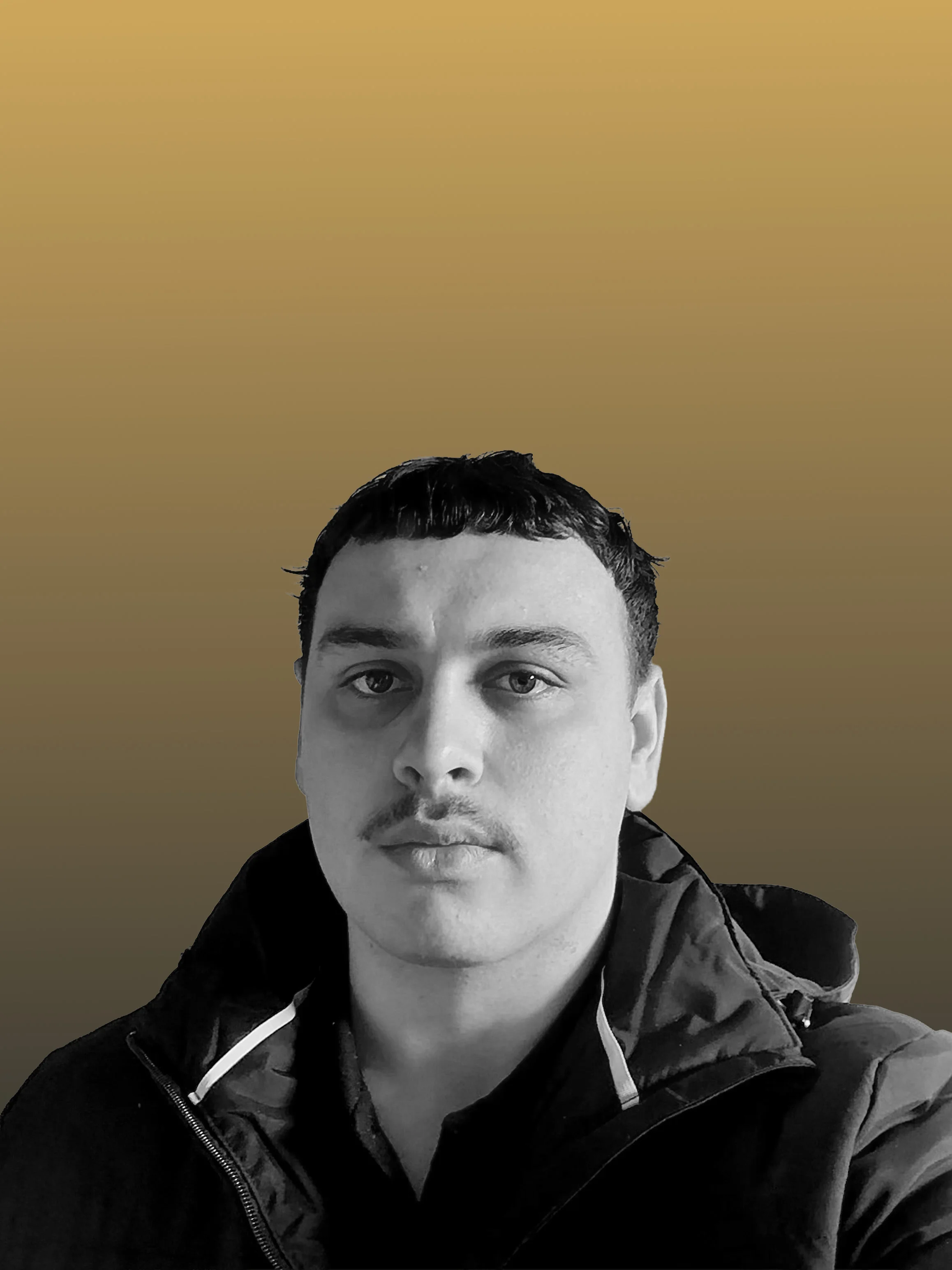 A person with short dark hair and a mustache wears a dark jacket, looking directly at the camera. The background has a gradient from gold at the top to dark gray at the bottom.